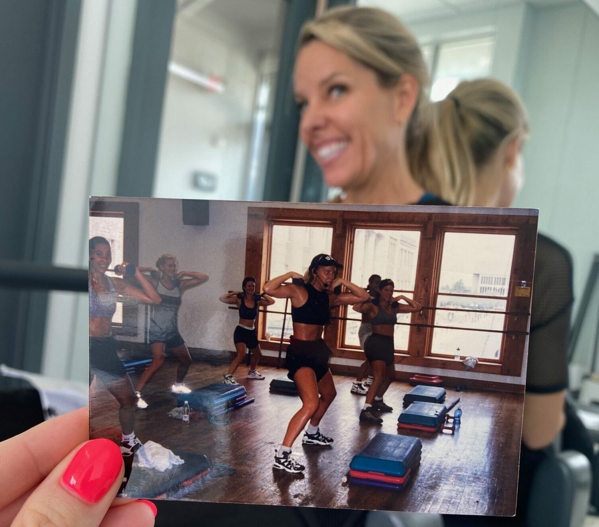 Throwback photo of a young Jenni Bruning Brown teaching fitness with Jenni today in the background